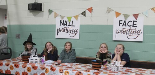Youth girls staff a booth at the children's Reformation Party in October